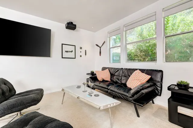 Aviator's Suite, Lakeway, TX vacation rental: Sofa Bed on living Room, 65" Smart Tv, modified air Plane wing coffee table.