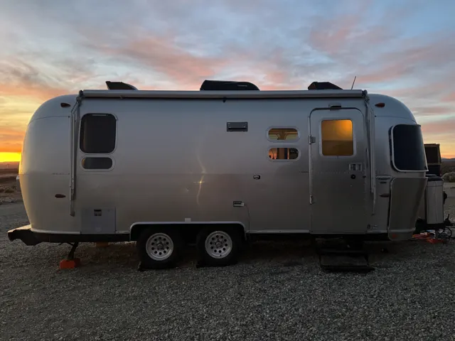 Travel trailer: Vintage aluminum travel trailer at sunset, side view